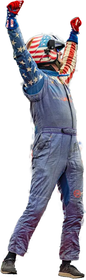 A Summernats USA driver in a stars-and-stripes race suit, arms raised