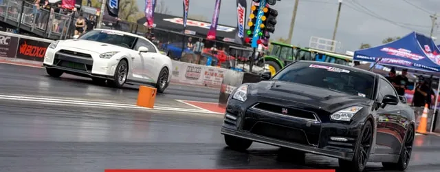 Two Nissan GT-Rs side by side on the strip for a roll race