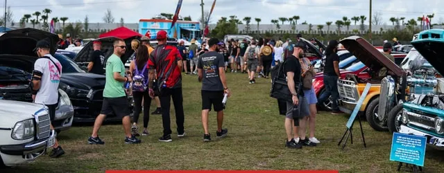 Crowds walking the Show N Shine lines between open-hood cars
